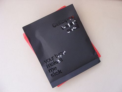 Black mylar packaging with glossy typography text, showcasing a creative design for bold branding.