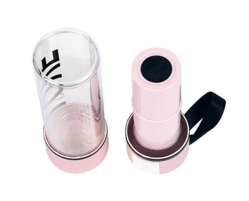 Transparent plastic lip balm containers with eco-friendly cardboard base.