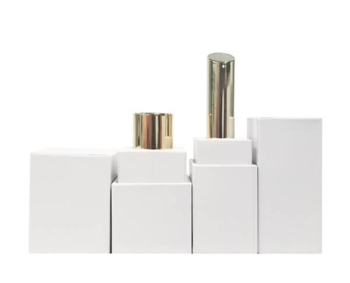 Sustainable empty lipstick packaging showcasing a minimalist cardboard exterior and metallic interior.