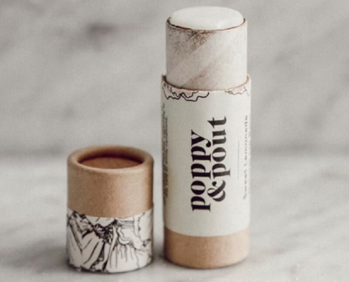 Eco-friendly cardboard lip balm tubes filled with natural lip balm for zero-waste beauty packaging