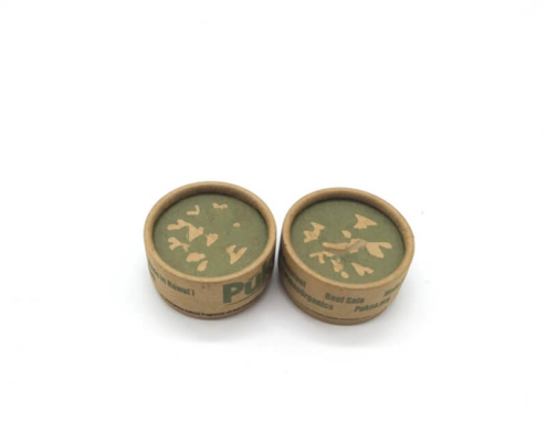 Eco-friendly kraft paper cream jars with dual-layer parchment lining for oil resistance.