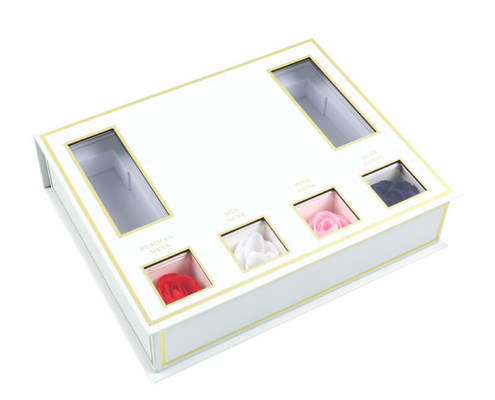 Red rigid box packaging for perfume sampler set, featuring a magnetic closure and custom inserts for organizing sample bottles.