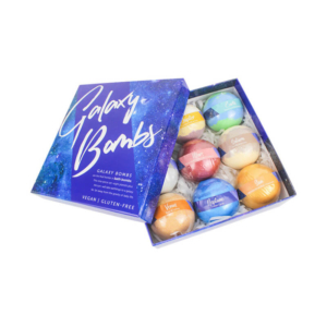 Galaxy-themed bath bomb box packaging – A vibrant blue box labeled "Galaxy Bombs," containing colorful bath bombs inspired by planetary names, with clear labeling and an elegant design.