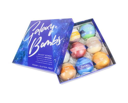 Galaxy-themed bath bomb box packaging – A vibrant blue box labeled "Galaxy Bombs," containing colorful bath bombs inspired by planetary names, with clear labeling and an elegant design.