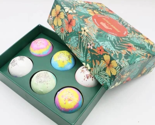 Floral-themed bath bomb box packaging with a tropical design – A decorative green box with floral patterns, holding six color-rich bath bombs with glitter details, perfect for seasonal or themed gifting.