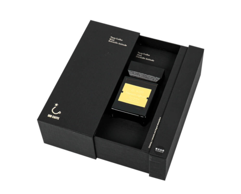 Open reed diffuser box packaging in a luxury black rigid drawer box with gold accents, showing secure EVA foam insert for product protection.