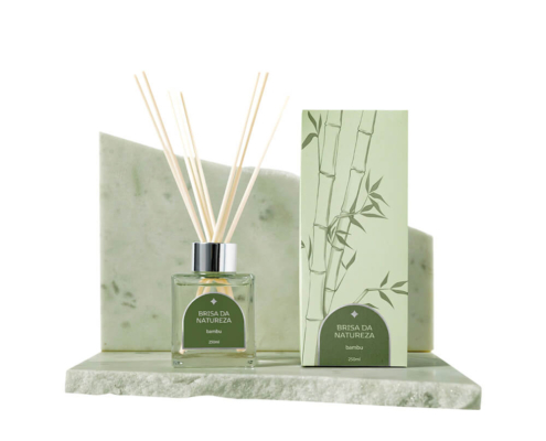 Reed diffuser box with bamboo design and glass bottle on marble base