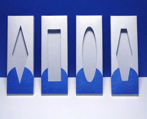 Four press on nail packaging box designs with various window shapes on a blue background.