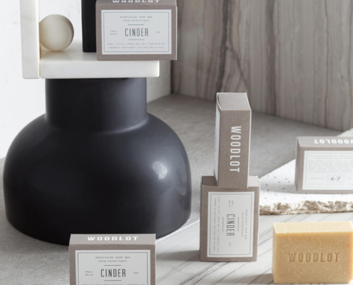 Minimalist soap packaging boxes in neutral tones, crafted from premium cardboard, displayed alongside a natural soap bar.