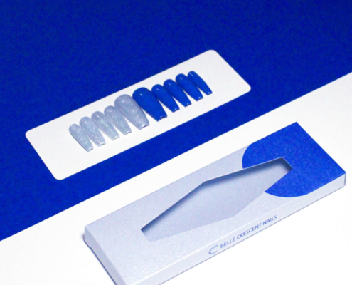 Diamond-shaped window press on nail packaging box featuring a display of blue and silver nails.