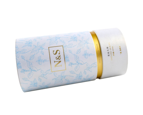 Foundation packaging tube lying down, showing detailed design and gold accents.