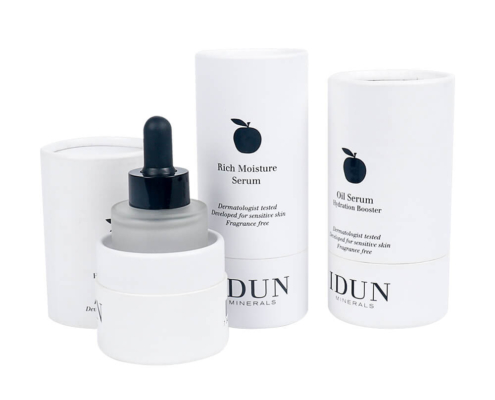 Face serum packaging tubes displayed with bottle inside, showcasing protective fit and minimalist style.