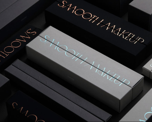 Makeup brush boxes in black and gray with "Smooth Makeup" foil-stamped design.