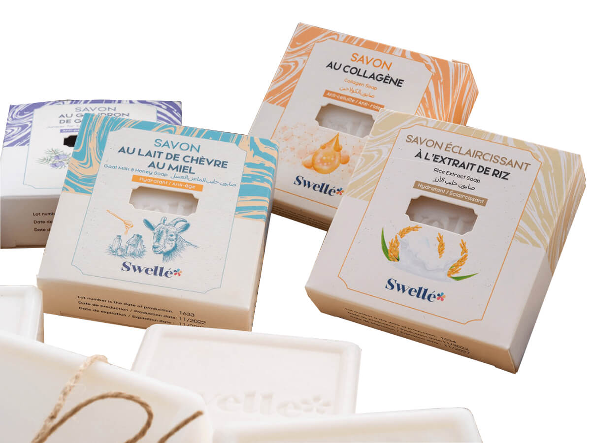 Custom folding carton packaging for handmade soaps with a clear window.