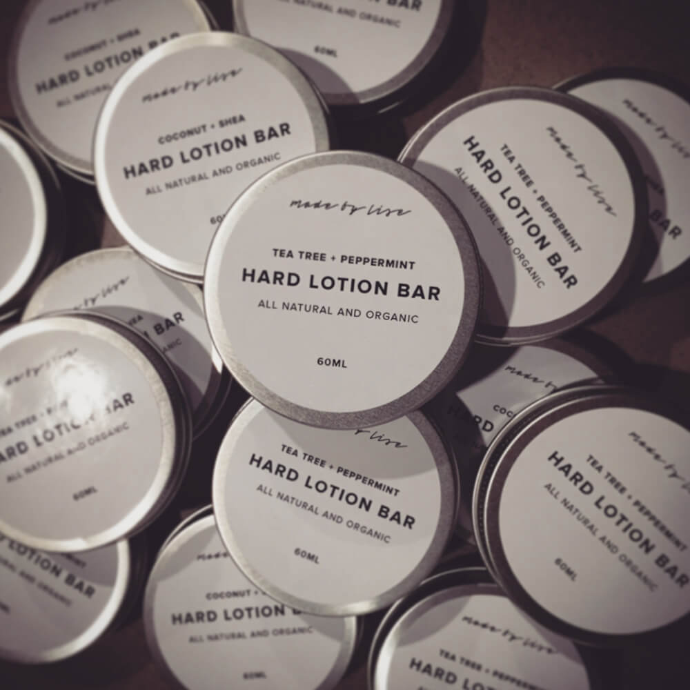 All-natural hard lotion bars packaged in round metal tins