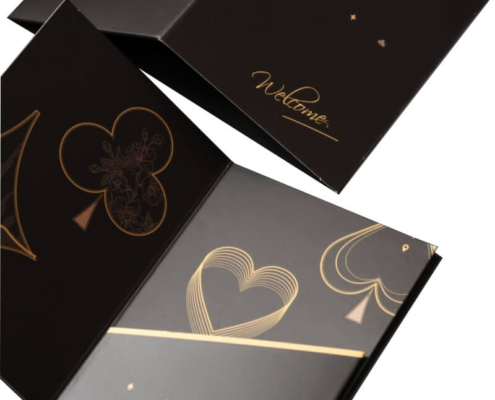 Open custom card holder with gold accents and artistic motifs – A close-up of an open black key card holder showcasing gold heart and club designs, ideal for luxury hotels to present room keys stylishly.