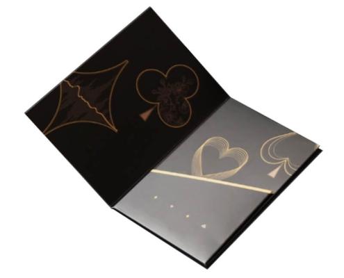 Foldable black hotel key card holder with decorative elements – An open black custom card holder with gold suit patterns, designed to provide secure storage for key cards and marketing materials, enhancing the hotel’s branding.