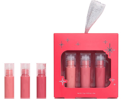 Open view of lip gloss box set with three individual gloss tubes alongside the packaging