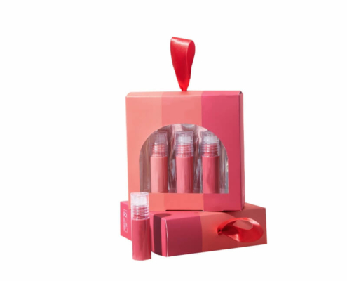 Pink and red gradient lip gloss box set with three glosses and a red ribbon handle