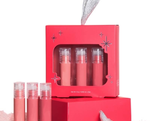 Red lip gloss box set with silver handle displayed alongside three lip gloss tubes