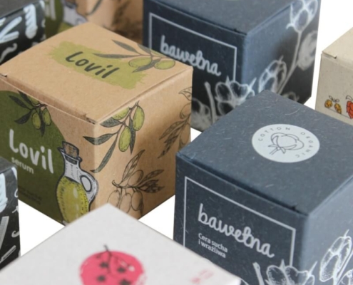 Collection of kraft serum boxes with distinct organic illustrations for skincare products.