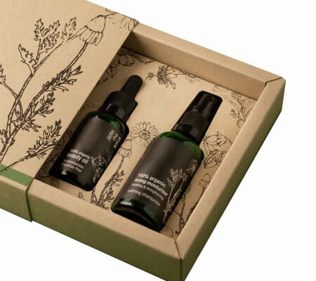 Close-up of eco-friendly skincare box with inserted serum and spray bottles, perfect for organic skincare brands.