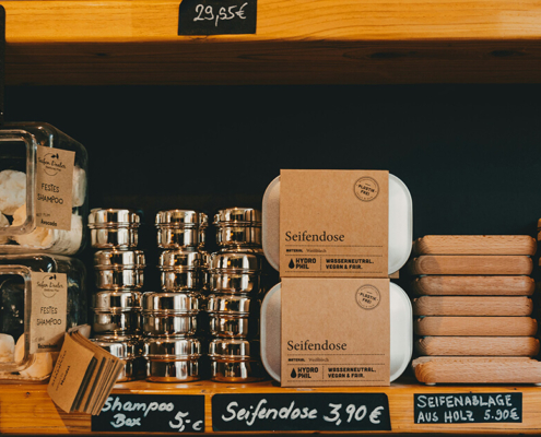 soaps packed in brown kraft paper sleeves and displayed in the shelf