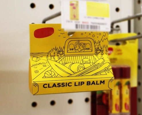 Chapstick packaging displayed on a retail pegboard shelf for visibility