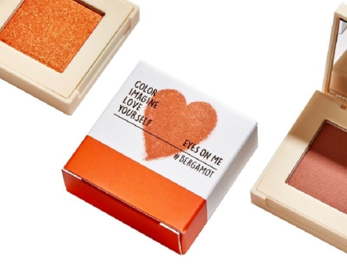 Custom eyeshadow box with spot UV finish and vibrant orange accent, showcasing premium packaging for makeup products.