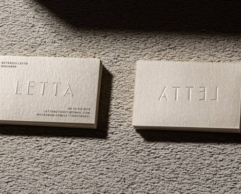 Embossed business cards with raised lettering, showcasing the word "LETTA" in a minimalist design.