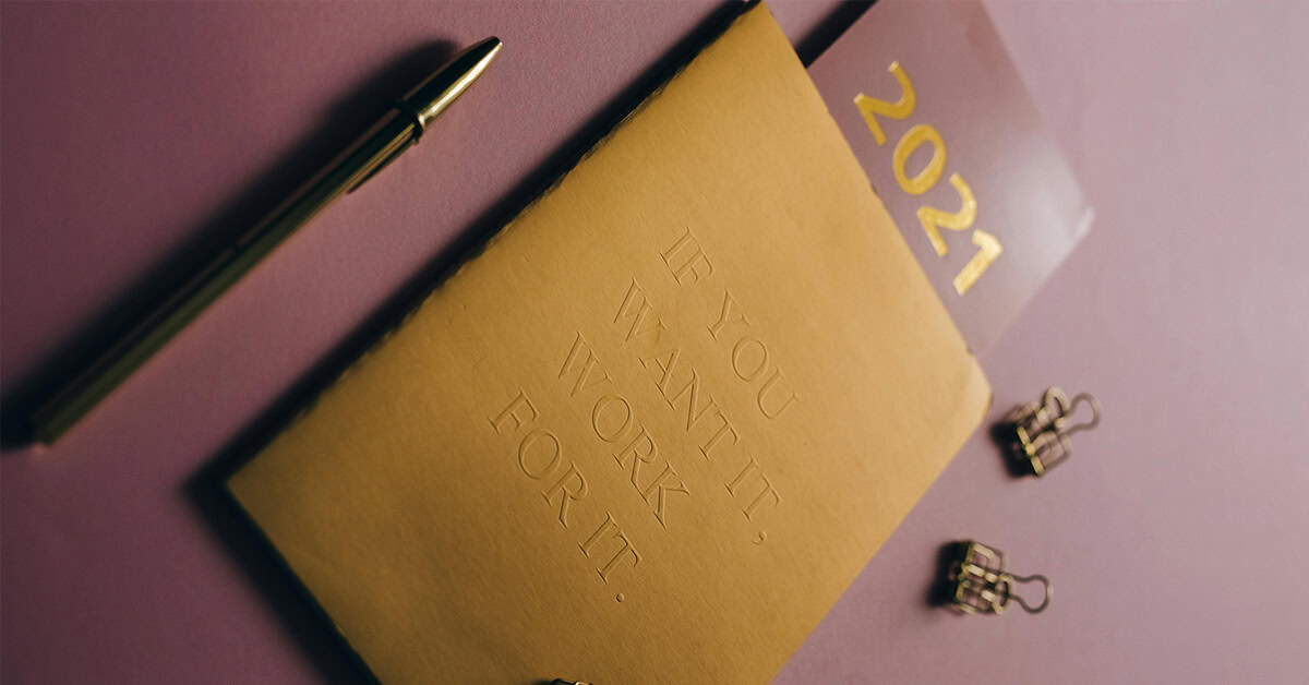 Debossed cover of a planner with the phrase "IF YOU WANT IT, WORK FOR IT" in a golden color.