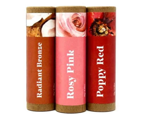 Set of three custom lip gloss tubes in Radiant Bronze, Rosy Pink, and Poppy Red with vibrant labels