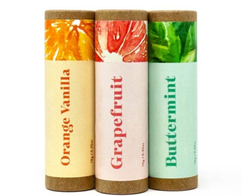 Custom lip gloss tubes in Orange Vanilla, Grapefruit, and Buttermint design with colorful labels