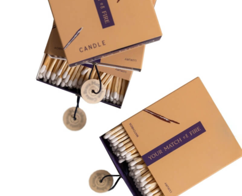 Luxury match packaging with a striking orange and navy blue design, featuring a matchbox-style box for candles.