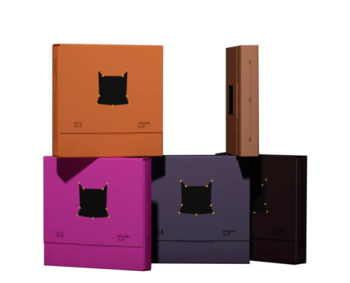 Stacked powder puff boxes in various colors, displaying their customizable design and sophisticated packaging.