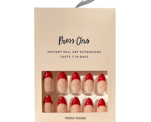 Press on nail box with 'Pearly Please' design, featuring red tips and pearl embellishments for a classic chic style.