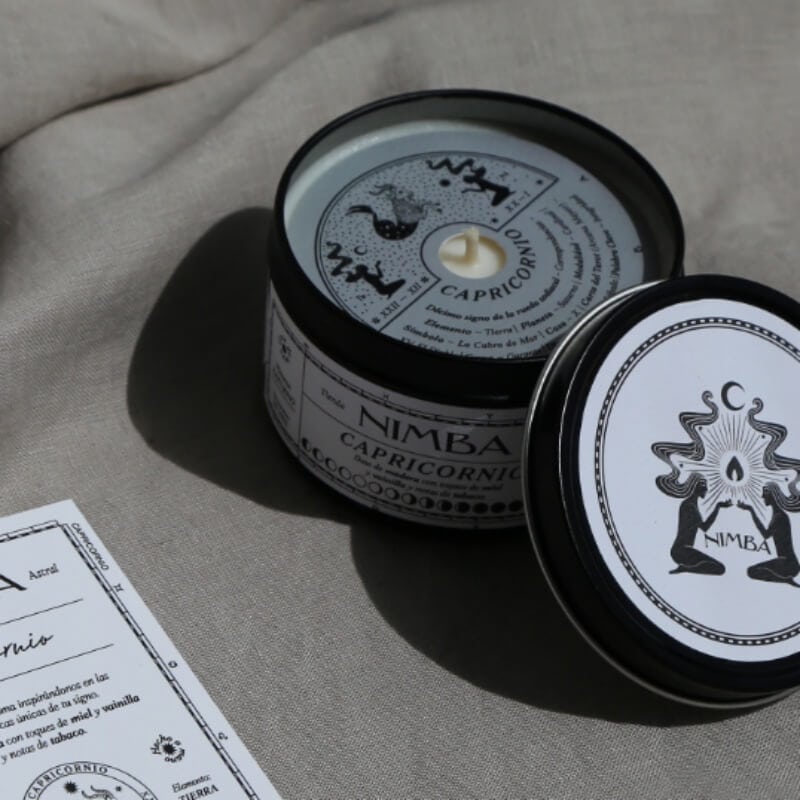 Black candle dust cover with intricate zodiac sign design and accompanying label, offering a personalized and artistic touch to your candle collection.