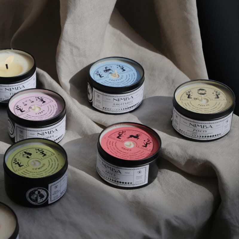 Set of colorful candle dust covers featuring zodiac symbols, each with customizable scent labels for a unique and personalized gift or collection.