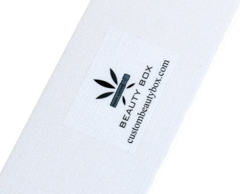 Close-up of custom logo sticker on pearlescent triangle lip balm box