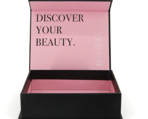 Interior view of black rigid nail polish set box with pink lining and compartments for multiple nail polish bottles.