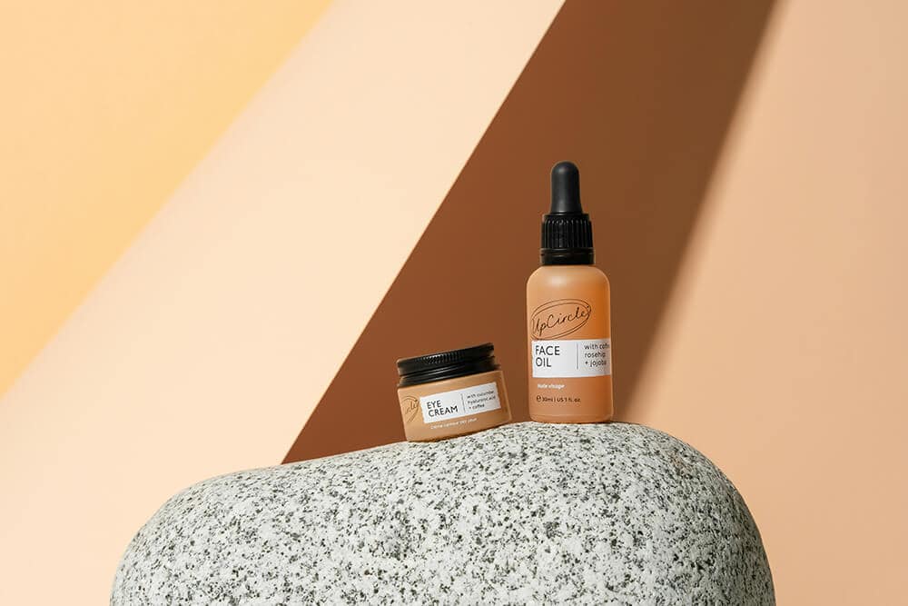 Skincare face oil and eye cream bottles with minimalist packaging.