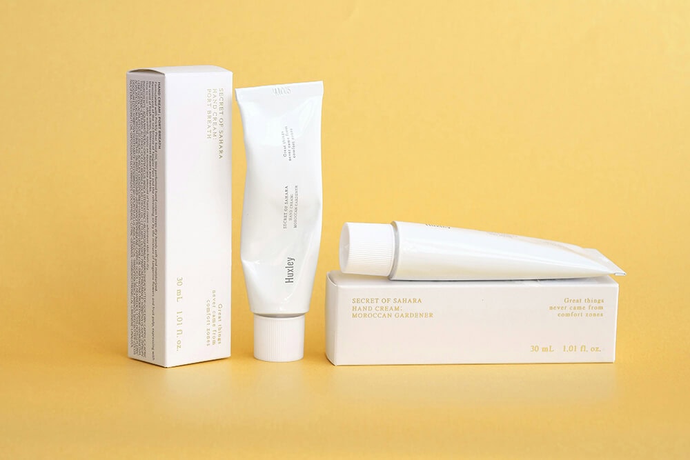 Hand cream and packaging with minimalist design elements.