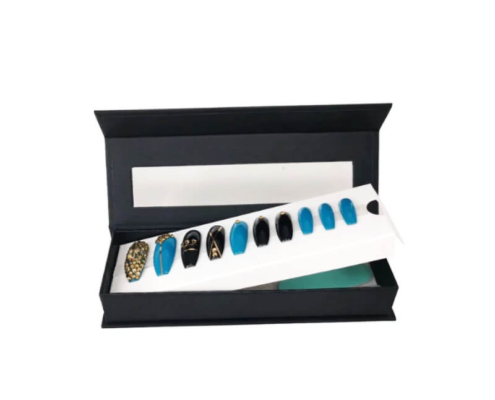 Custom magnetic nail packaging box displaying decorative press-on nails in an open-lid view.