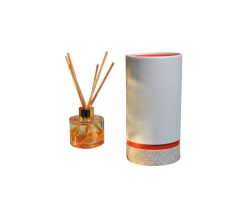 Sunlit eco-friendly reed diffuser packaging wholesale with gold cap and orange trim design.
