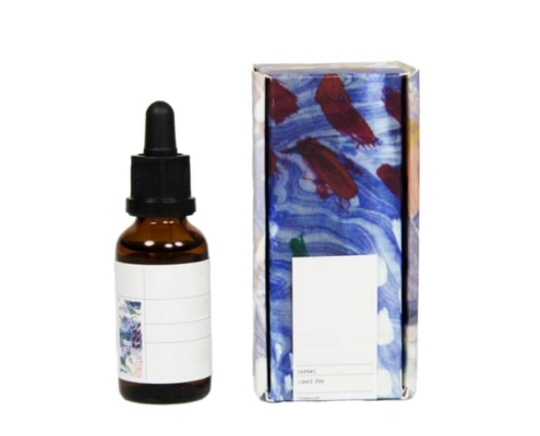 Colorful printed serum boxes with flip top design and matching glass serum bottle – premium serum boxes for cosmetic products.