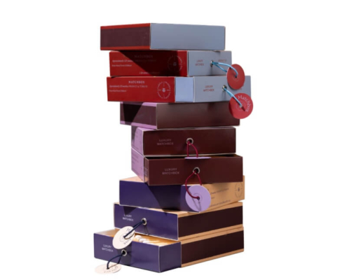 Stack of colorful custom sliding drawer boxes with hang tags for branding