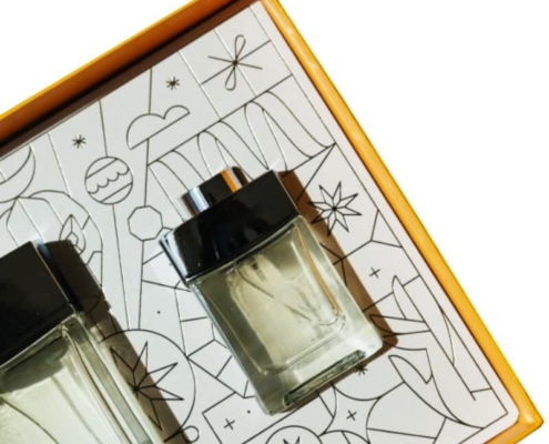 Perfume box with geometric design featuring black and gold packaging for high-end fragrance